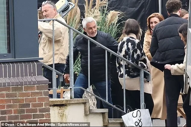 The crew and cast on the steps of the location during the shoot