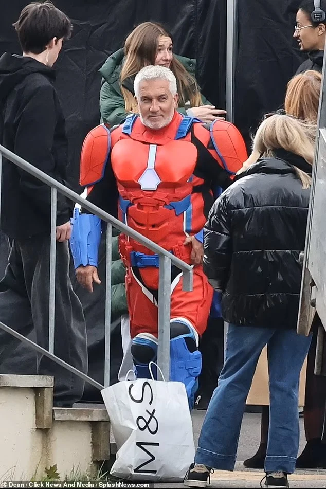 Paul Hollywood in a red and blue superhero costume between takes, photographed from off set