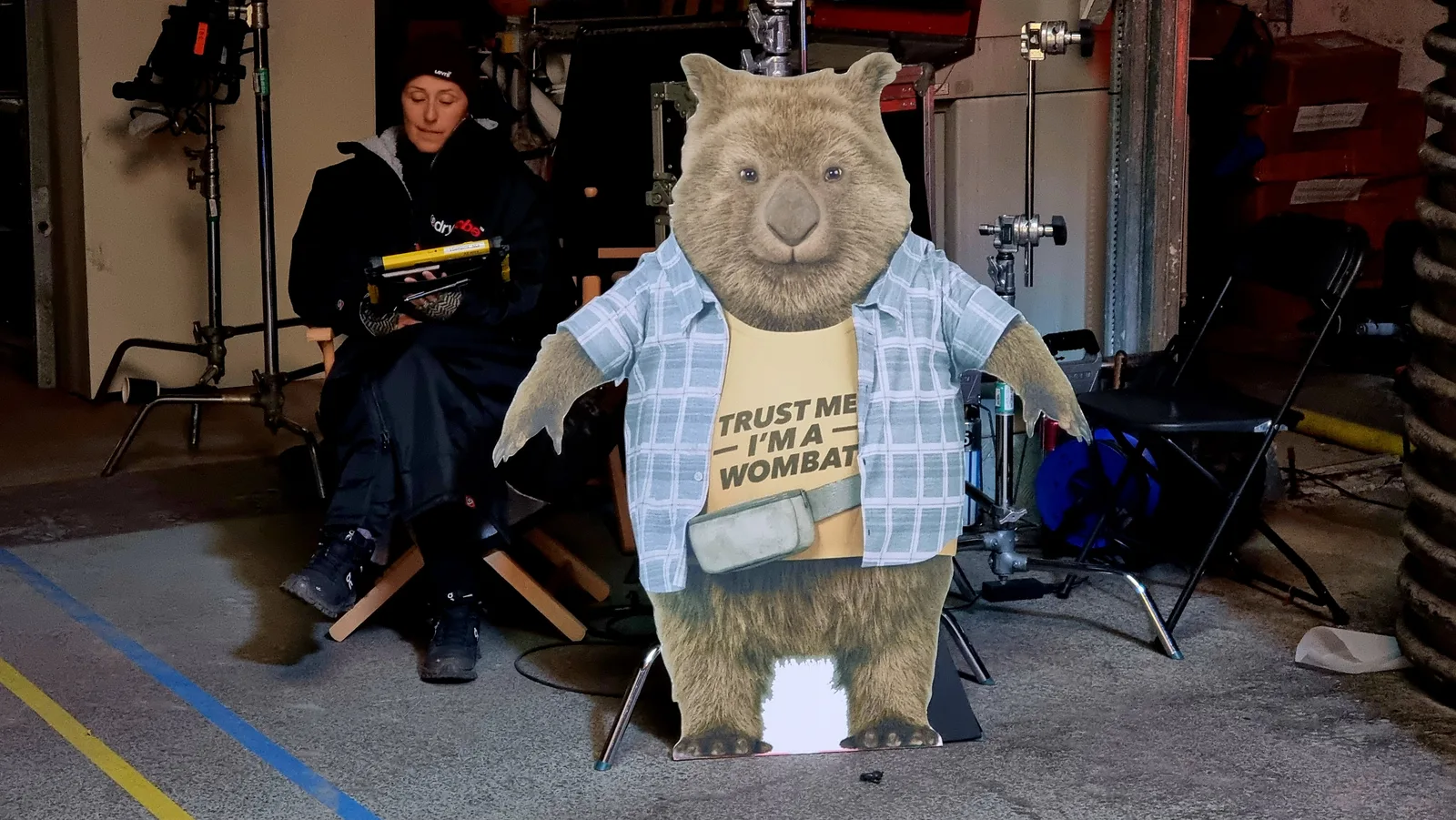 A wombat character standee on set reading ‘Trust me, I’m a wombat’