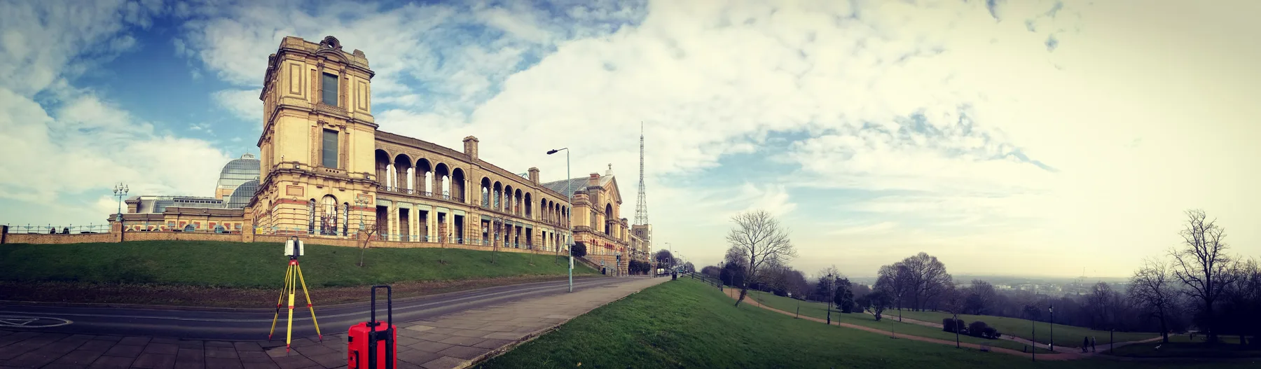 Panoramic view of the Royal Observatory with a survey tripod set up in the foreground