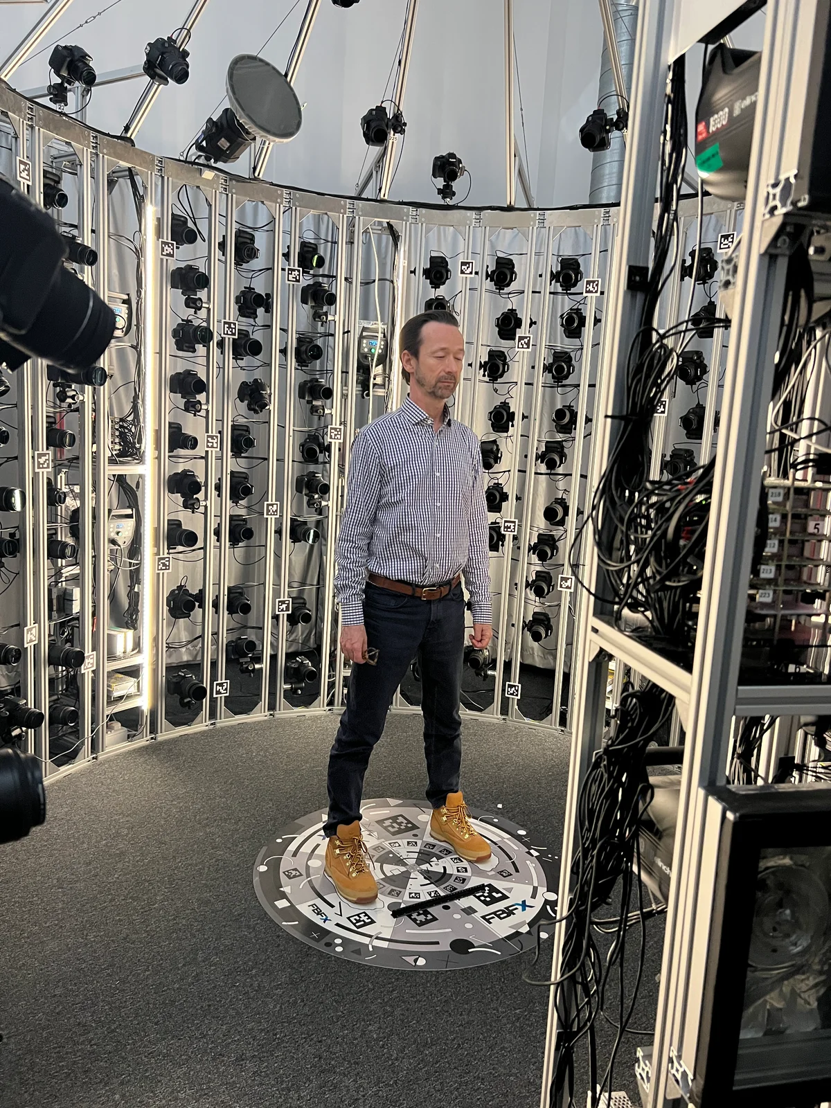 Second actor positioned in the multi-camera rig ready for capture