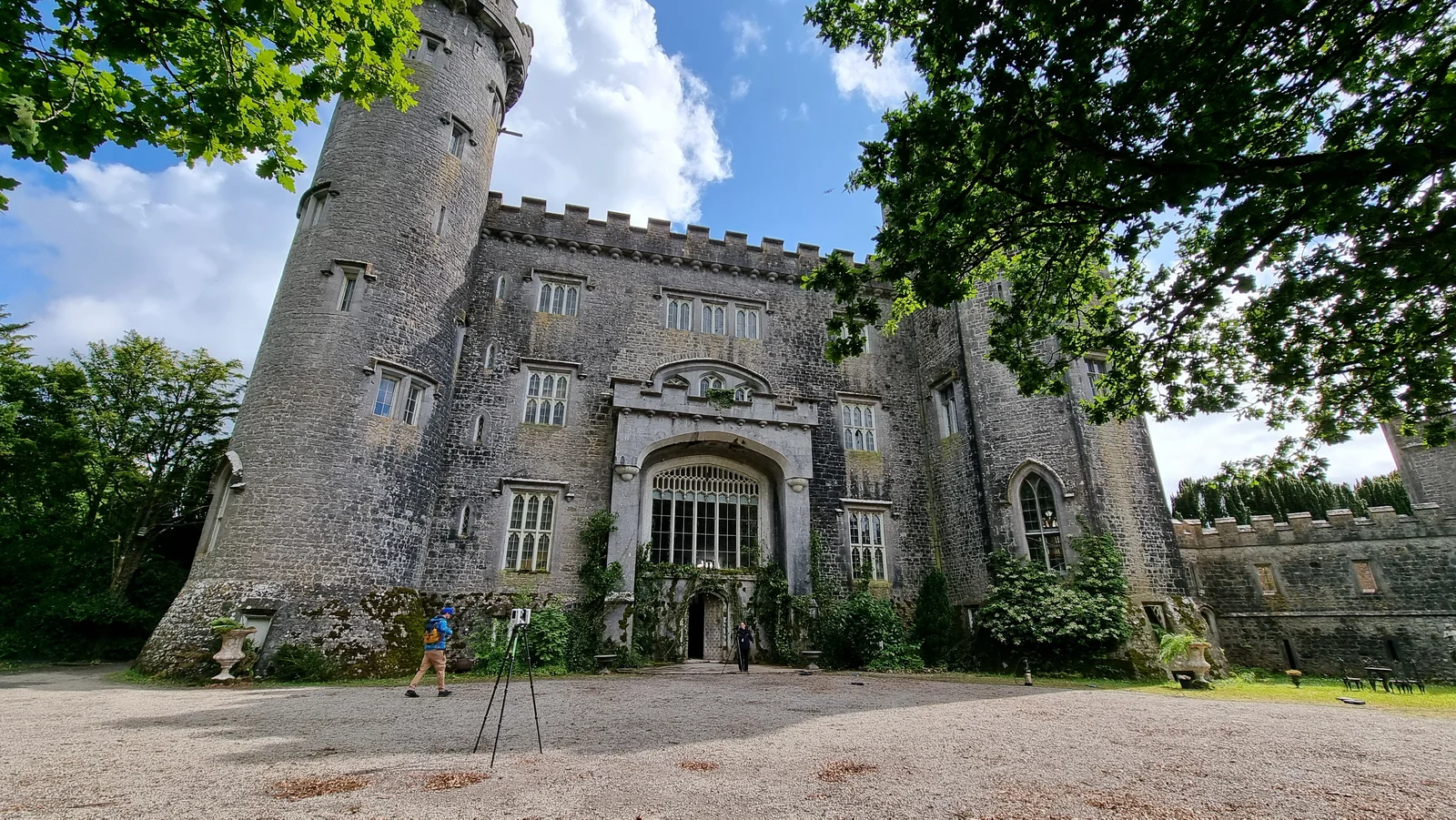 Charleville Castle from the grounds, with a survey tripod set up on the lawn