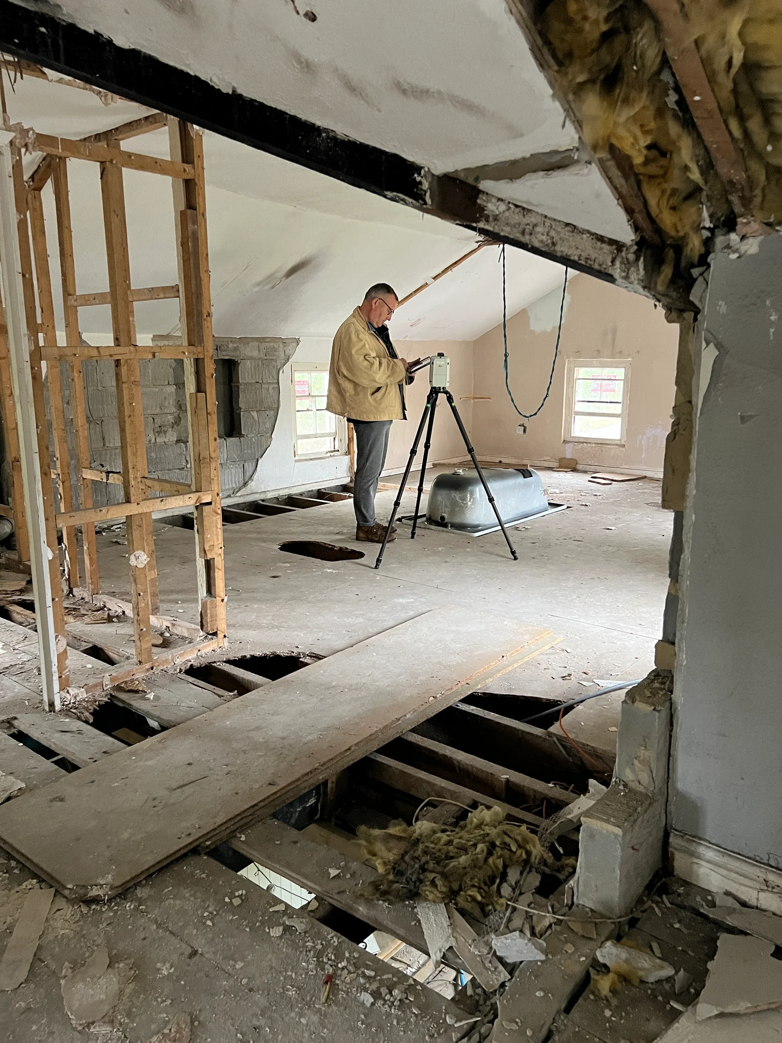 Surveyor scanning inside the stripped-back station interior