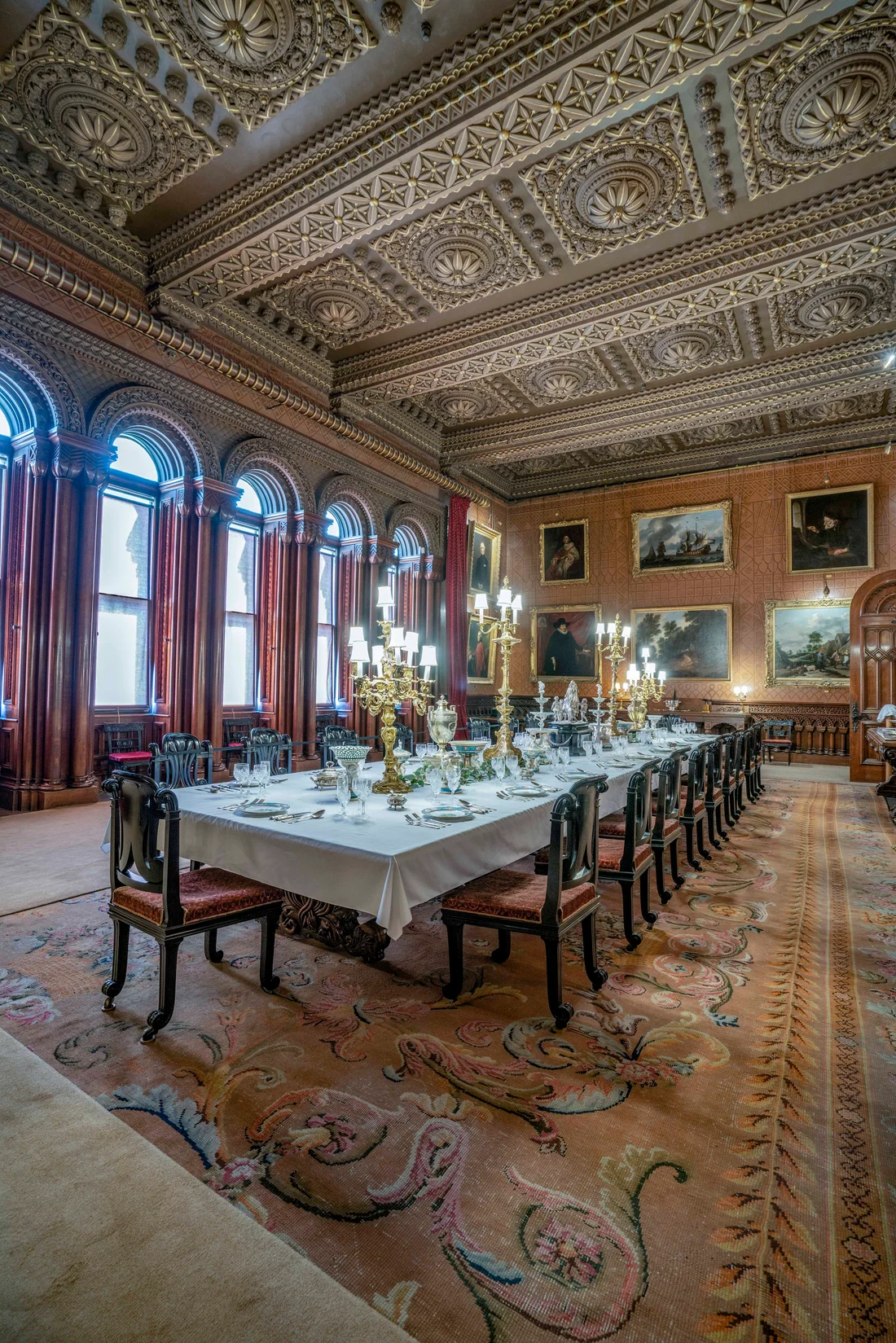 The dining room laid out beneath the painted ceiling