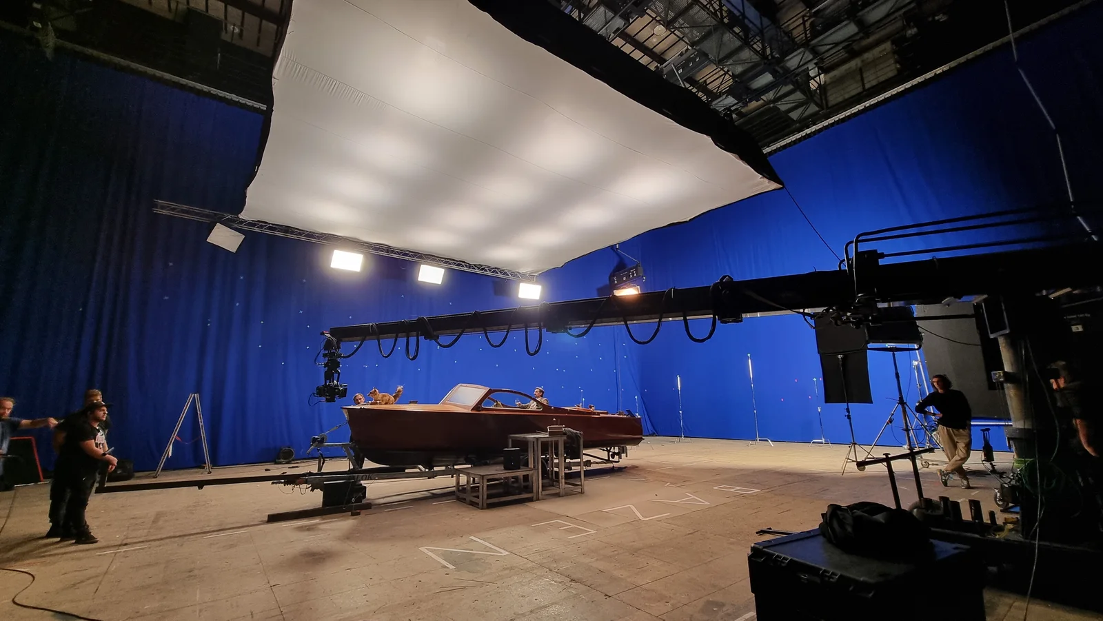 The speedboat lit on a blue screen stage with the lighting rig overhead