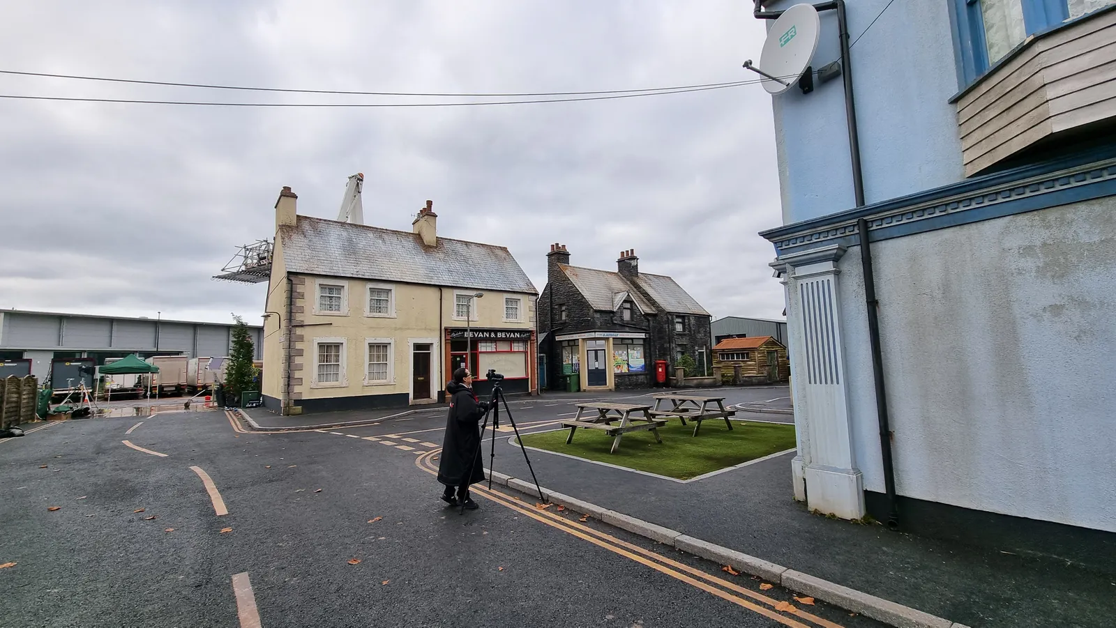 Behind the scenes at Dragon Studios in Cardiff - operator with a tripod-mounted laser scanner working the purpose-built street set