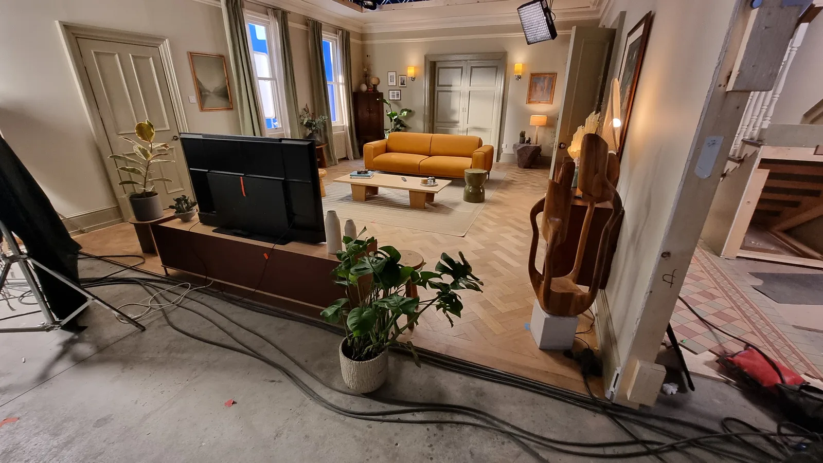The living room set dressed and lit on the sound stage