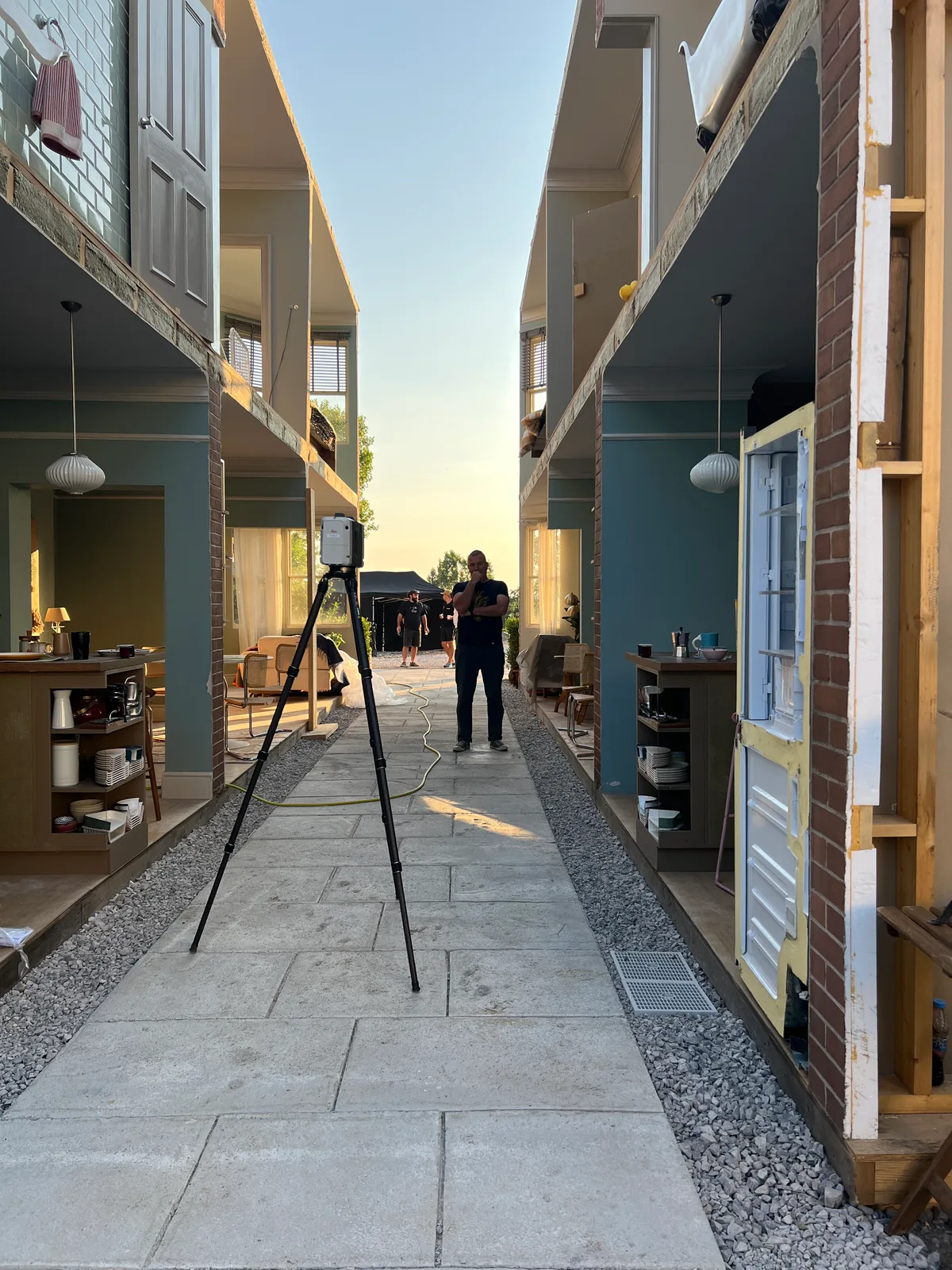 Terrestrial scanner set up in the alley between the street set houses