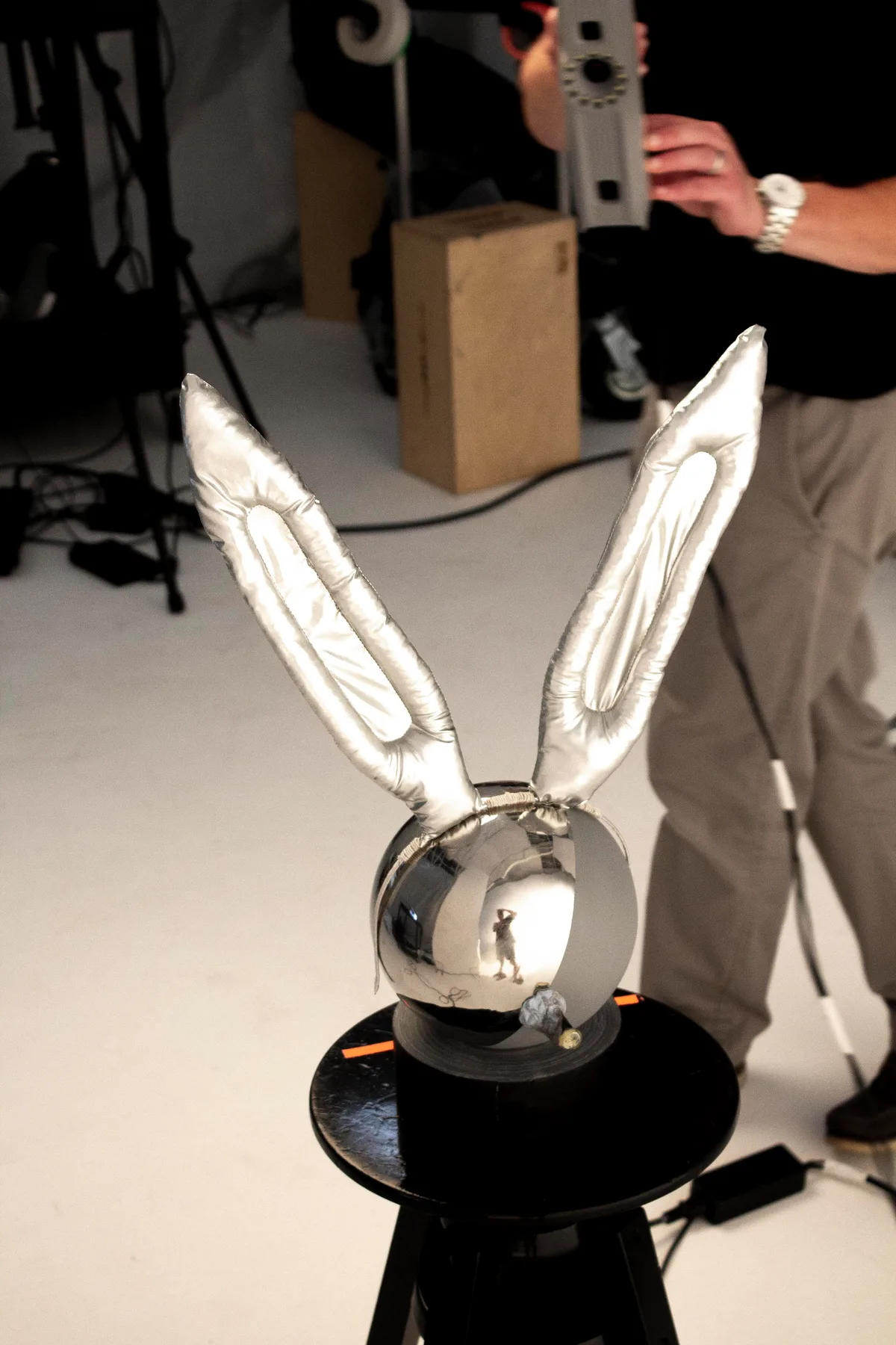 Chrome rabbit-ear prop on a turntable during capture