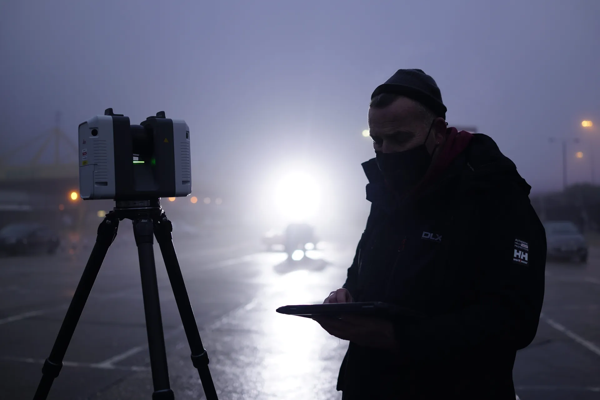 Duncan Lees operating terrestrial LiDAR scanner at dusk